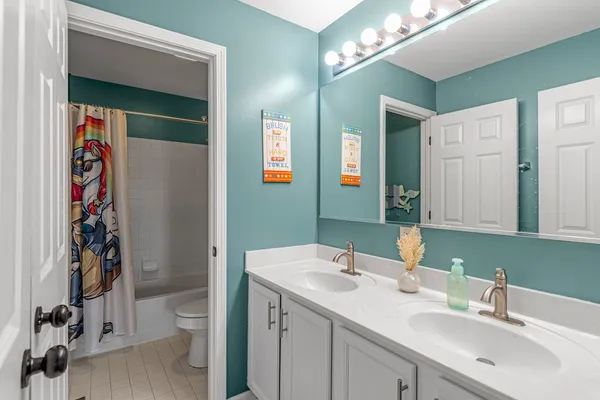 a view of a livingroom with wooden floor and a ceiling fan