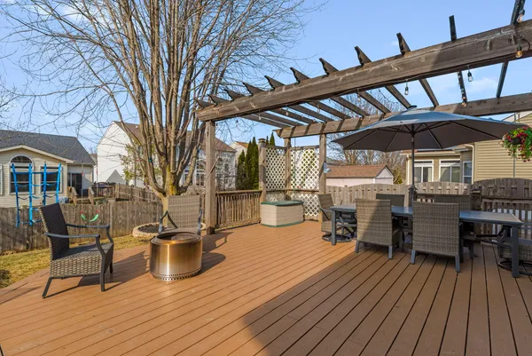 a backyard of a house with barbeque oven and outdoor seating