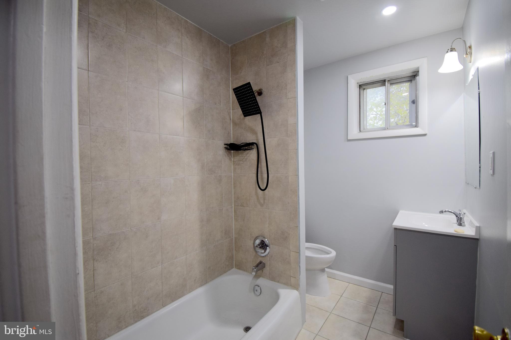 14017 Adkins Road Laurel, MD 20708 - Photo 15 of 18 a bathroom with a shower a toilet and a sink