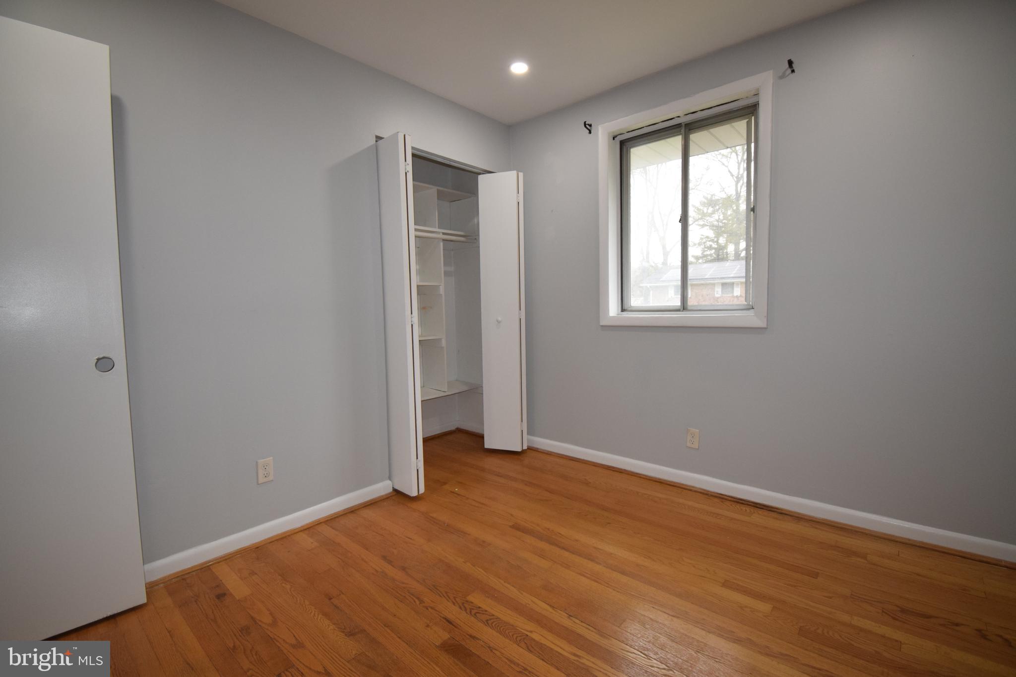 14017 Adkins Road Laurel, MD 20708 - Photo 6 of 18 an empty room with wooden floor and windows