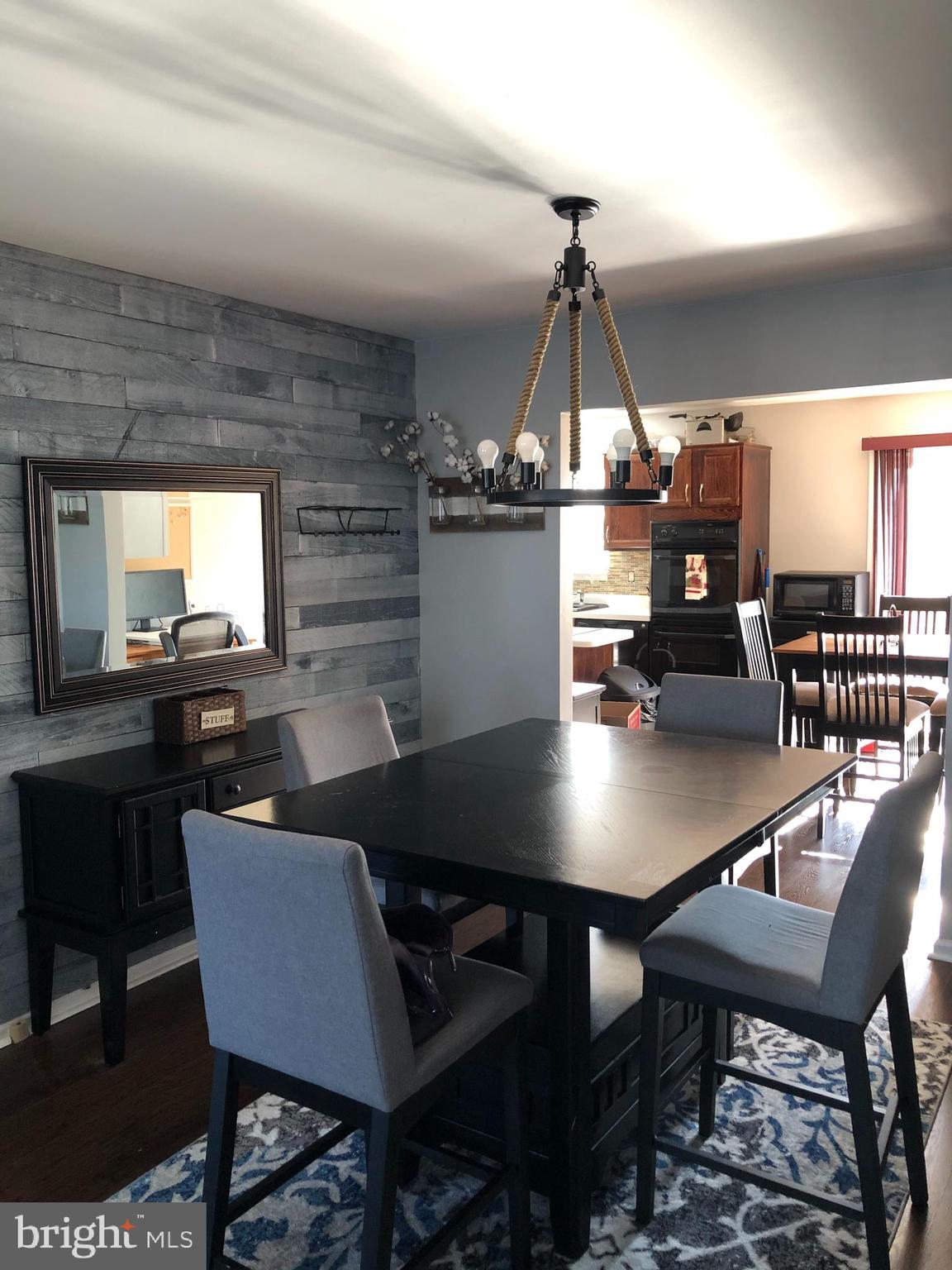 9087 Slate Stone Loop Bristow, VA 20136 - Photo 4 of 28 Dinning Room with Feature Wall