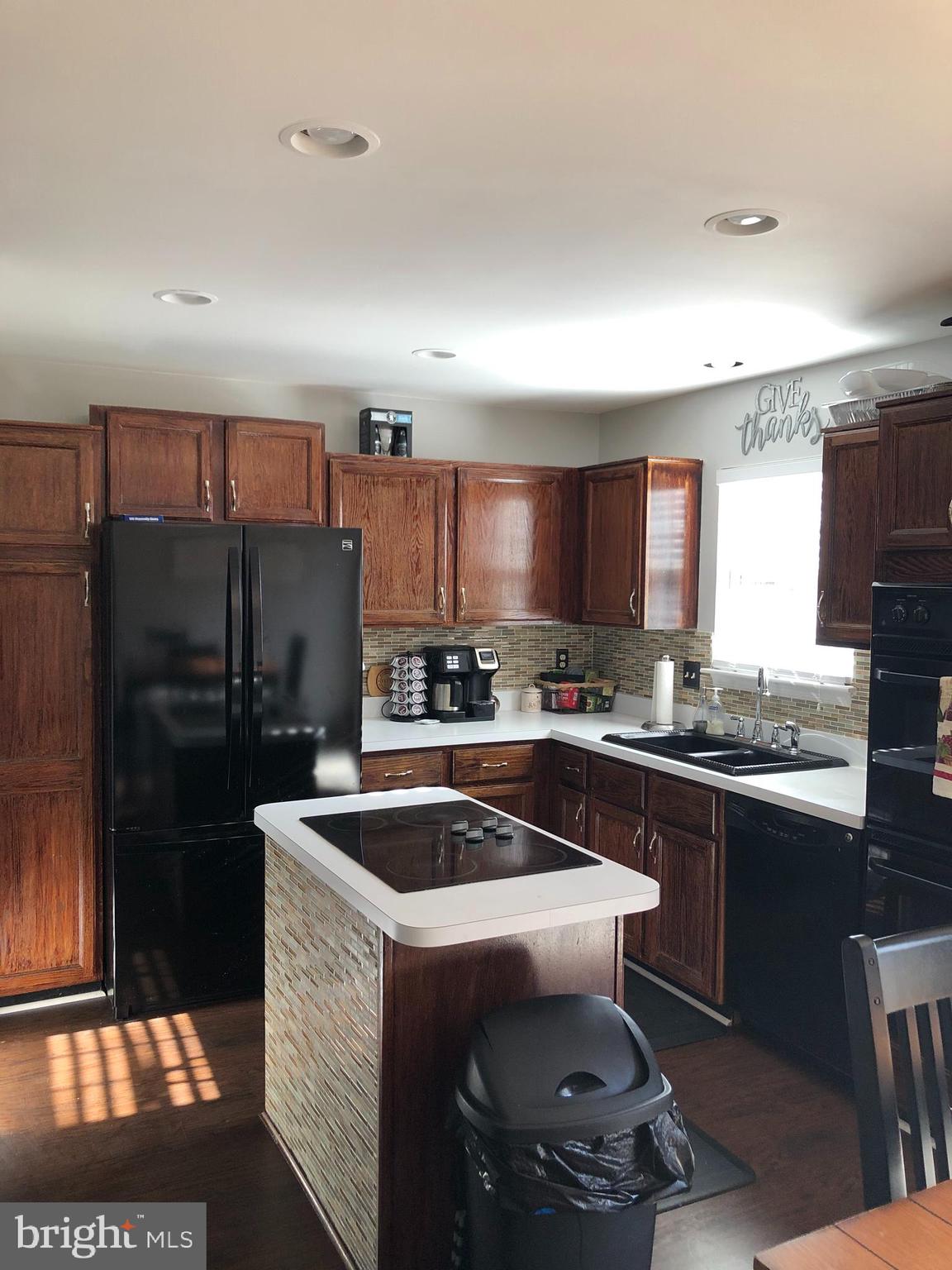 9087 Slate Stone Loop Bristow, VA 20136 - Photo 7 of 28 Kitchen with Island range cooktop and double ovens