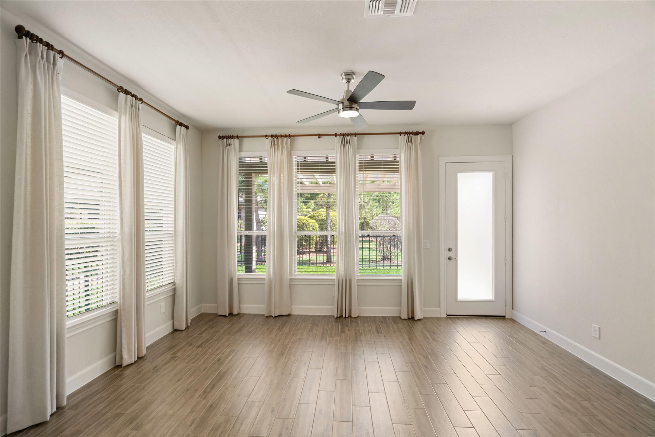 516 Nokota Drive Spring, TX 77382 - Photo 10 of 33 Sunroom is an extensive UPGRADE to the Martin Ray design adding square footage to the original plan and creating a blank canvas ready for your custom touch. Framed in custom window treatments and 2" blinds these oversized windows allow for abundant light filling the entire space. Huge plus is NO direct back neighbors creating a serene backdrop for your every day enjoyment.