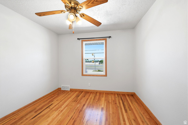 1180 North 400 East Bountiful, UT 84010 - Photo 26 of 50 Bright room featuring wood-finish flooring, white walls, and a ceiling fan with integrated lighting
