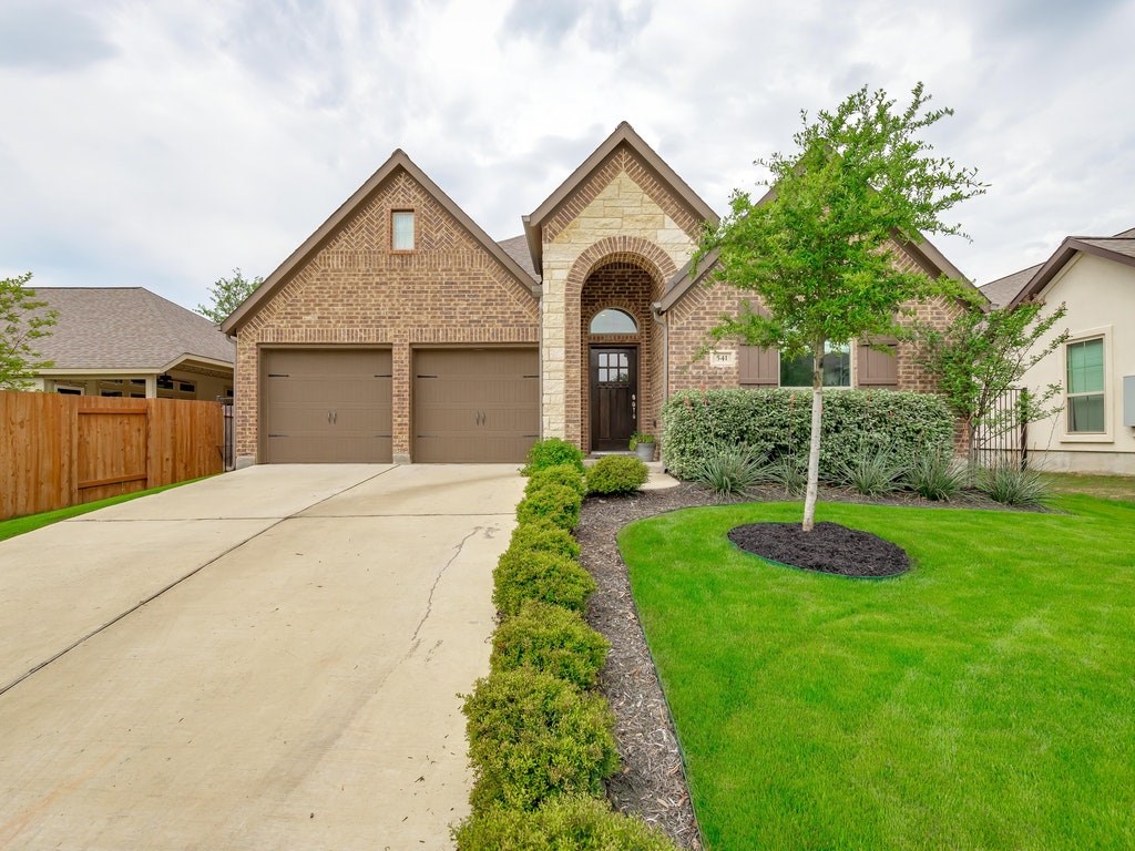 a front view of a house with a yard