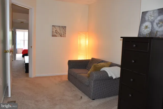 a living room with furniture and wall painting