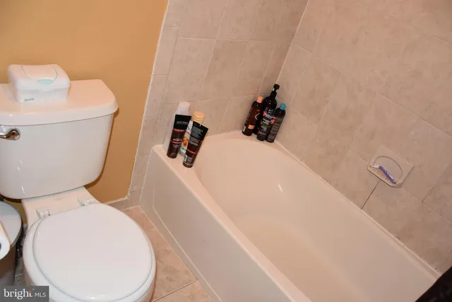 a white toilet sitting next to a white sink