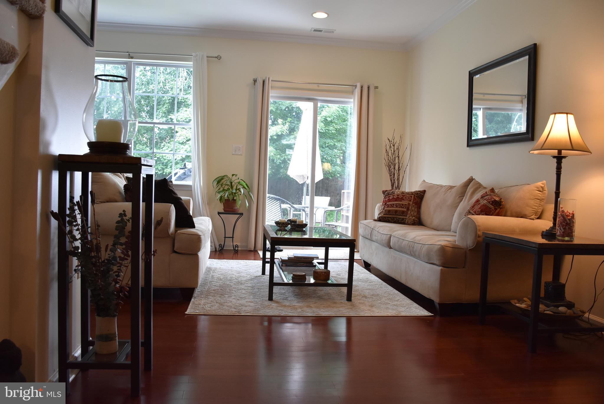 65 Heath Court Pennington, NJ 08534 - Photo 2 of 18 a living room with furniture wooden floor and a lamp
