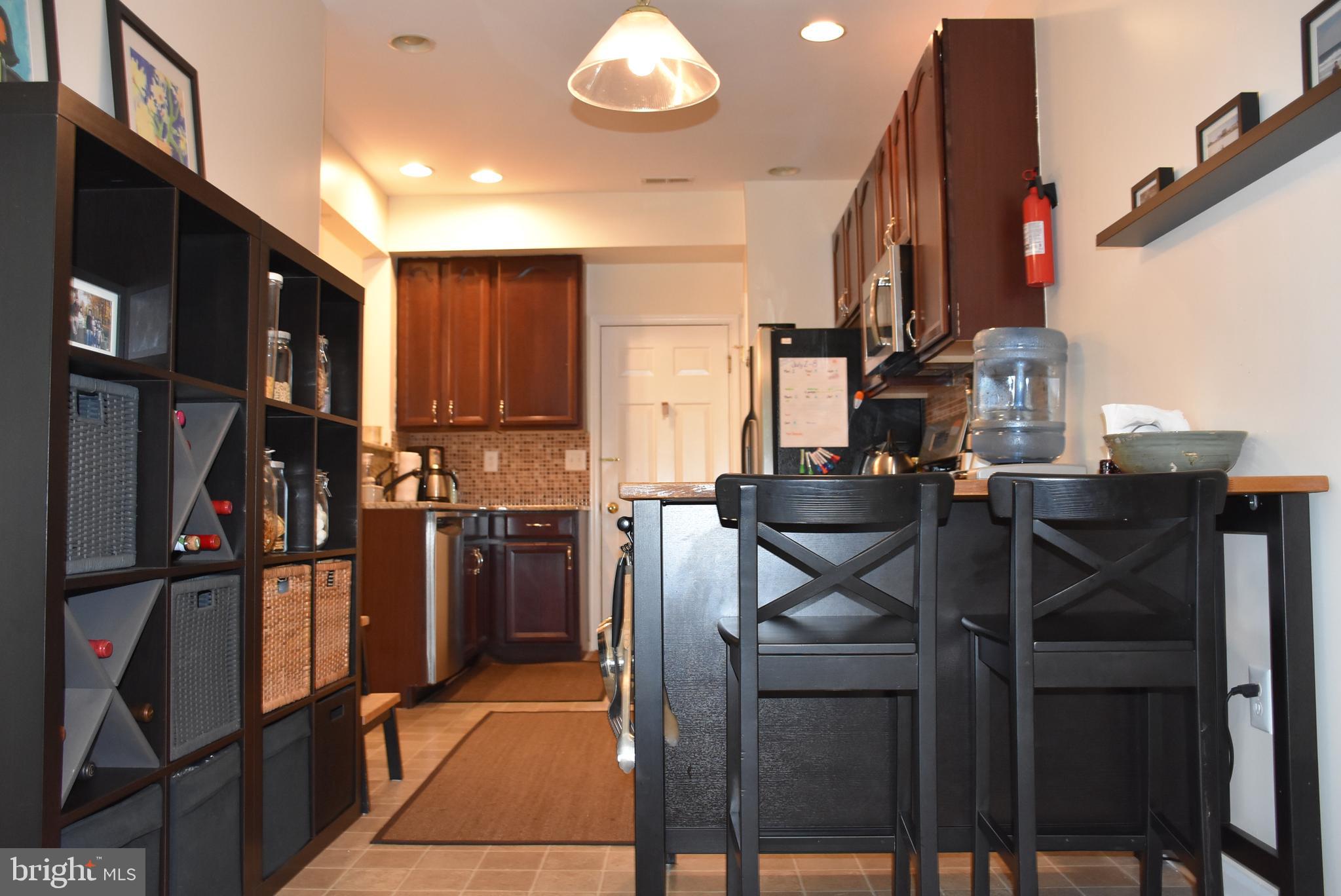65 Heath Court Pennington, NJ 08534 - Photo 8 of 18 a kitchen view of a refrigerator and chairs
