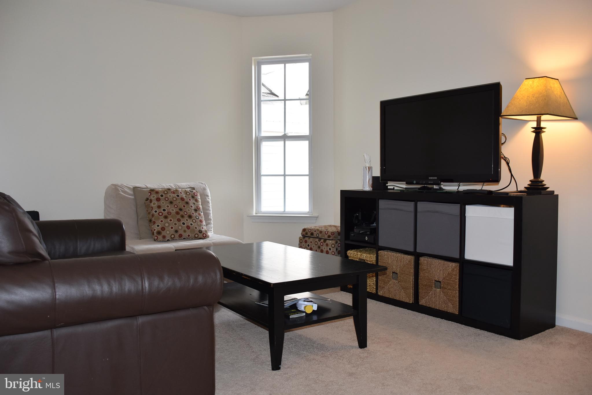 65 Heath Court Pennington, NJ 08534 - Photo 9 of 18 a living room with furniture and a flat screen tv