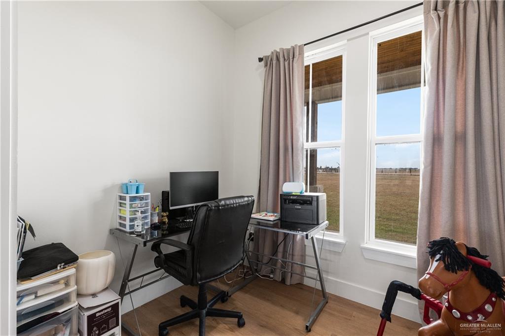 23588 Beefmaster Road Monte Alto, TX 78538 - Photo 15 of 45 a view of a workspace with furniture and a window