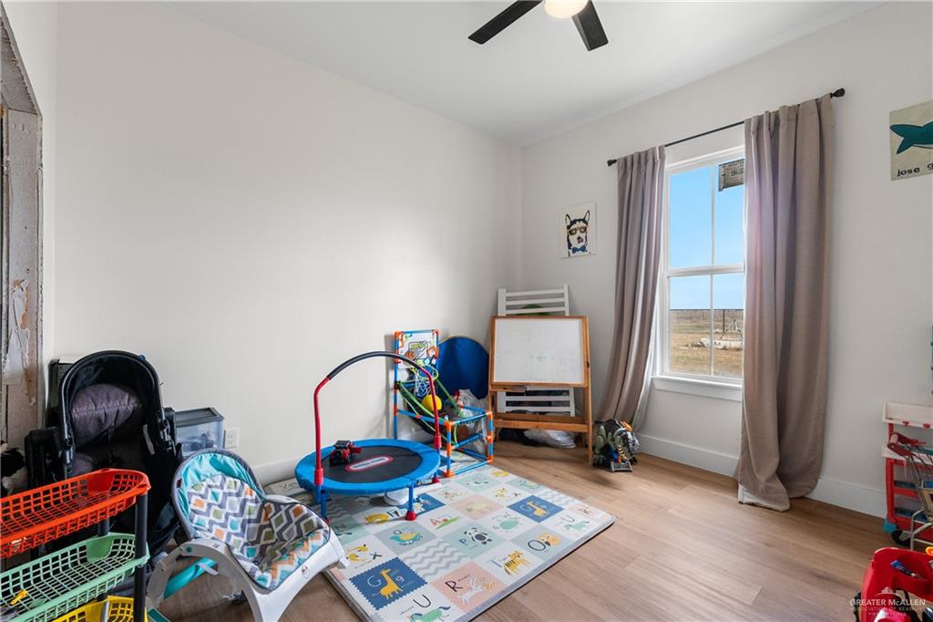 23588 Beefmaster Road Monte Alto, TX 78538 - Photo 18 of 45 a room with furniture and a wooden floor