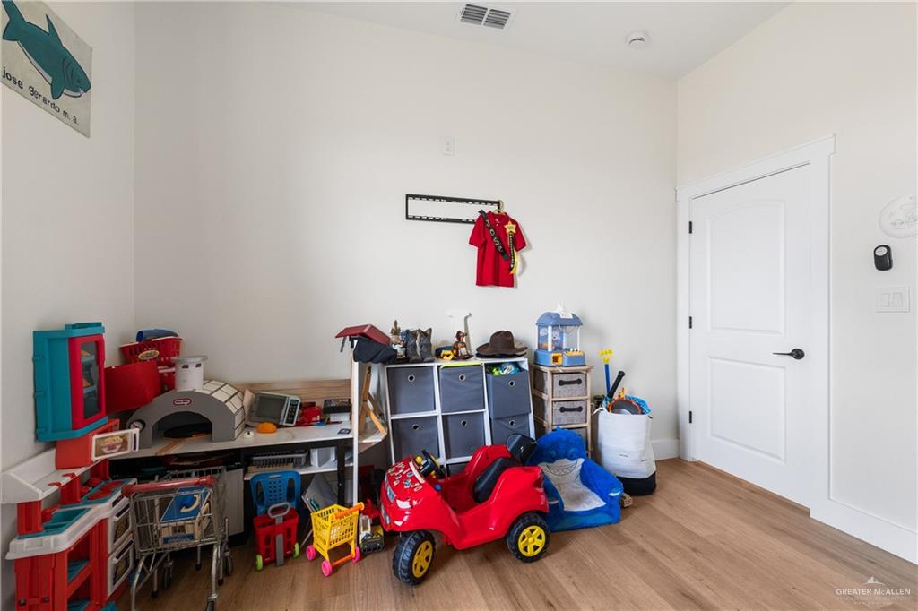 23588 Beefmaster Road Monte Alto, TX 78538 - Photo 19 of 45 a bedroom with furniture and a book shelf