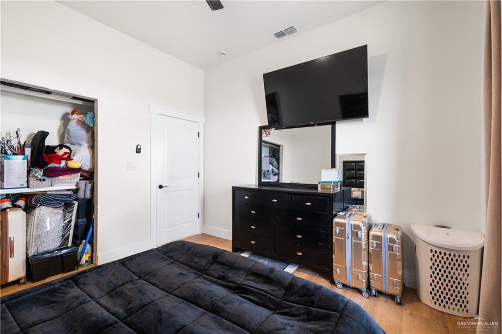 23588 Beefmaster Road Monte Alto, TX 78538 - Photo 22 of 45 a bedroom with a bed and a flat tv screen on wall