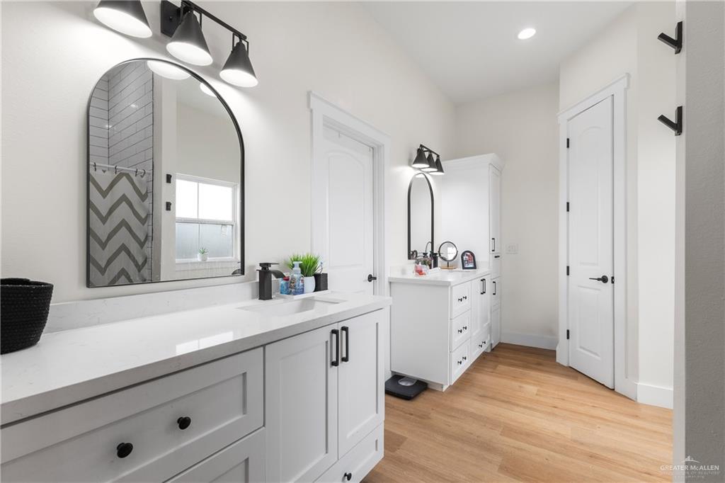 23588 Beefmaster Road Monte Alto, TX 78538 - Photo 25 of 45 a spacious bathroom with a double vanity sink and a mirror