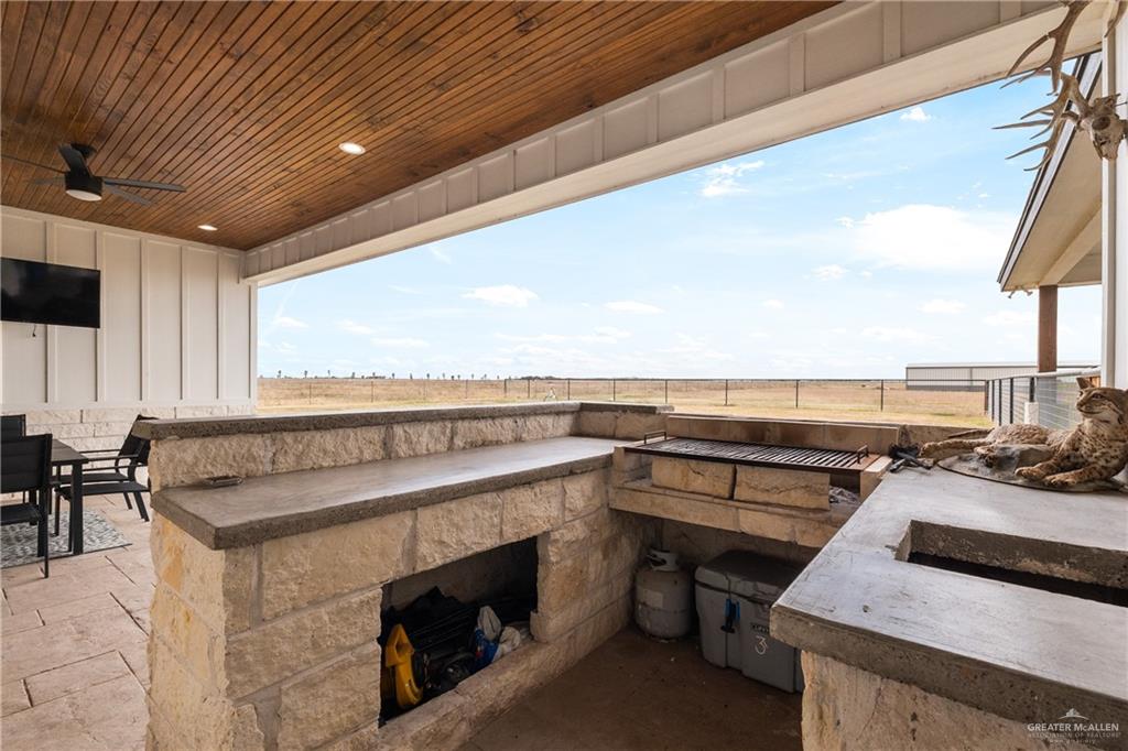 23588 Beefmaster Road Monte Alto, TX 78538 - Photo 30 of 45 a terrace with a table and chairs