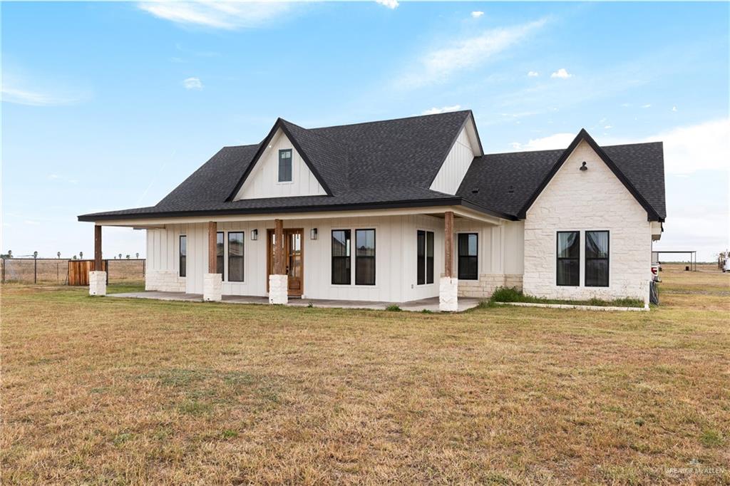 23588 Beefmaster Road Monte Alto, TX 78538 - Photo 3 of 45 a front view of a house with a yard