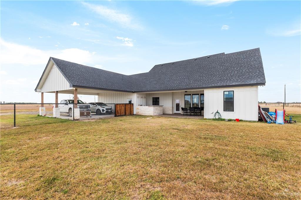 23588 Beefmaster Road Monte Alto, TX 78538 - Photo 4 of 45 a front view of a house with a garden and patio