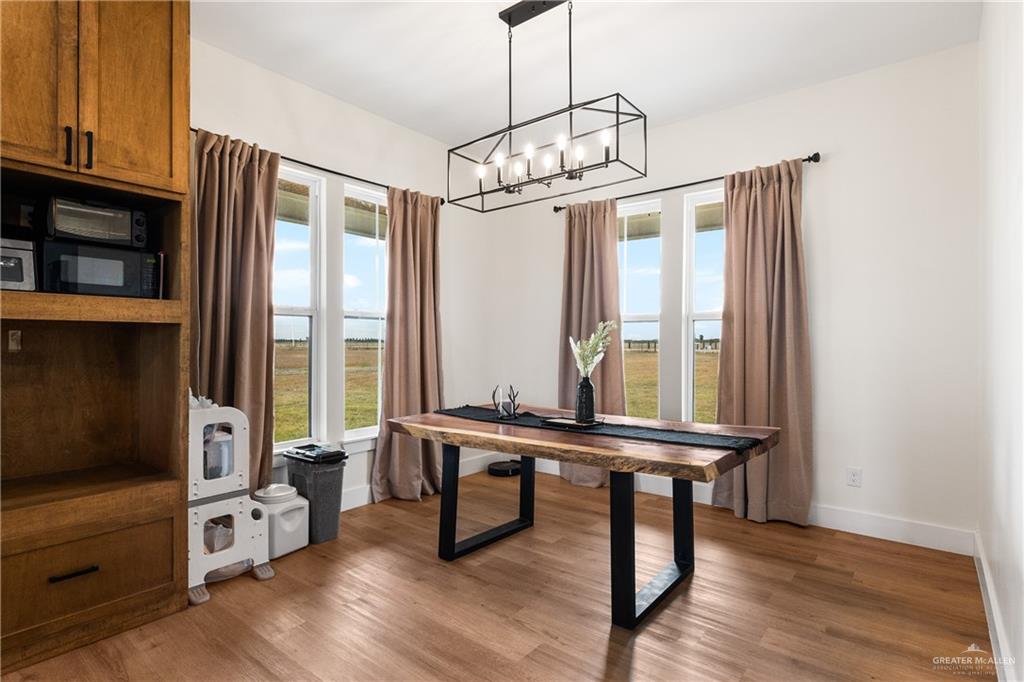 23588 Beefmaster Road Monte Alto, TX 78538 - Photo 9 of 45 a view of a livingroom with furniture window and wooden floor