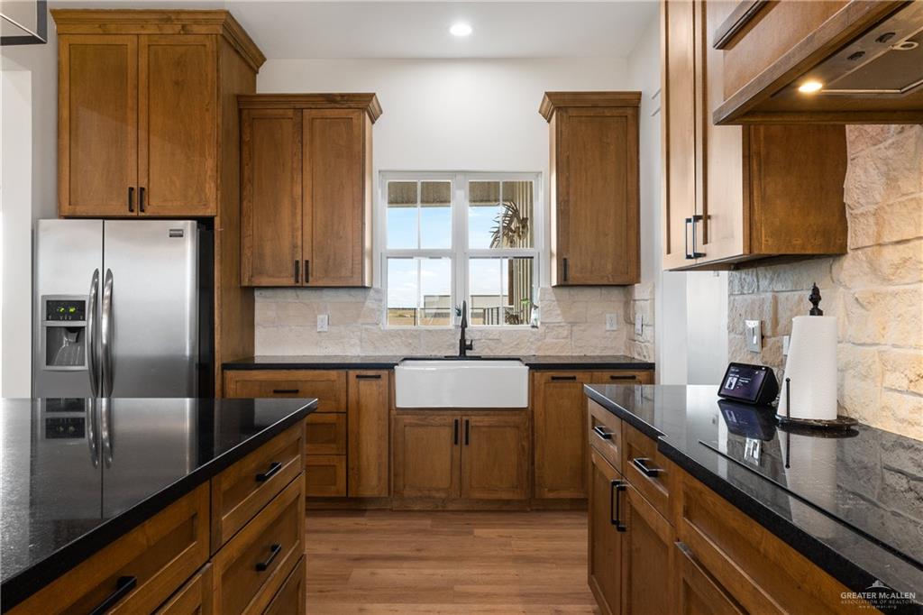 23588 Beefmaster Road Monte Alto, TX 78538 - Photo 10 of 45 a kitchen with stainless steel appliances granite countertop a sink stove and refrigerator