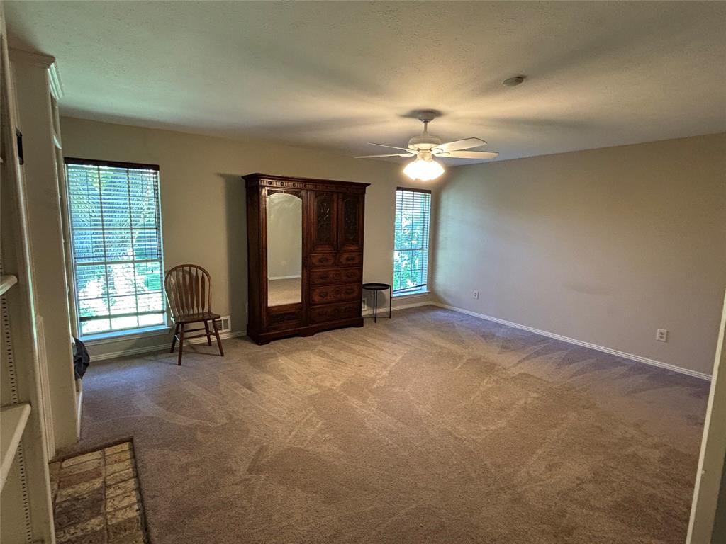 328 Ridge Crest Drive Richardson, TX 75080 - Photo 11 of 17 an empty room with windows and fan