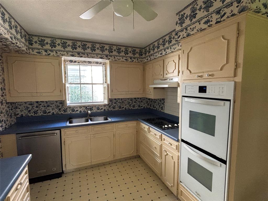 328 Ridge Crest Drive Richardson, TX 75080 - Photo 8 of 17 a kitchen with stainless steel appliances granite countertop a sink a stove a microwave a counter space and cabinets