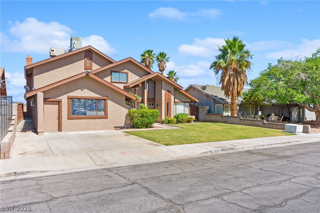 4430 Cranbrook Way Las Vegas, NV 89103 - Photo 3 of 50 A striking exterior presents a blend of architectural styles and vibrant green lawn.