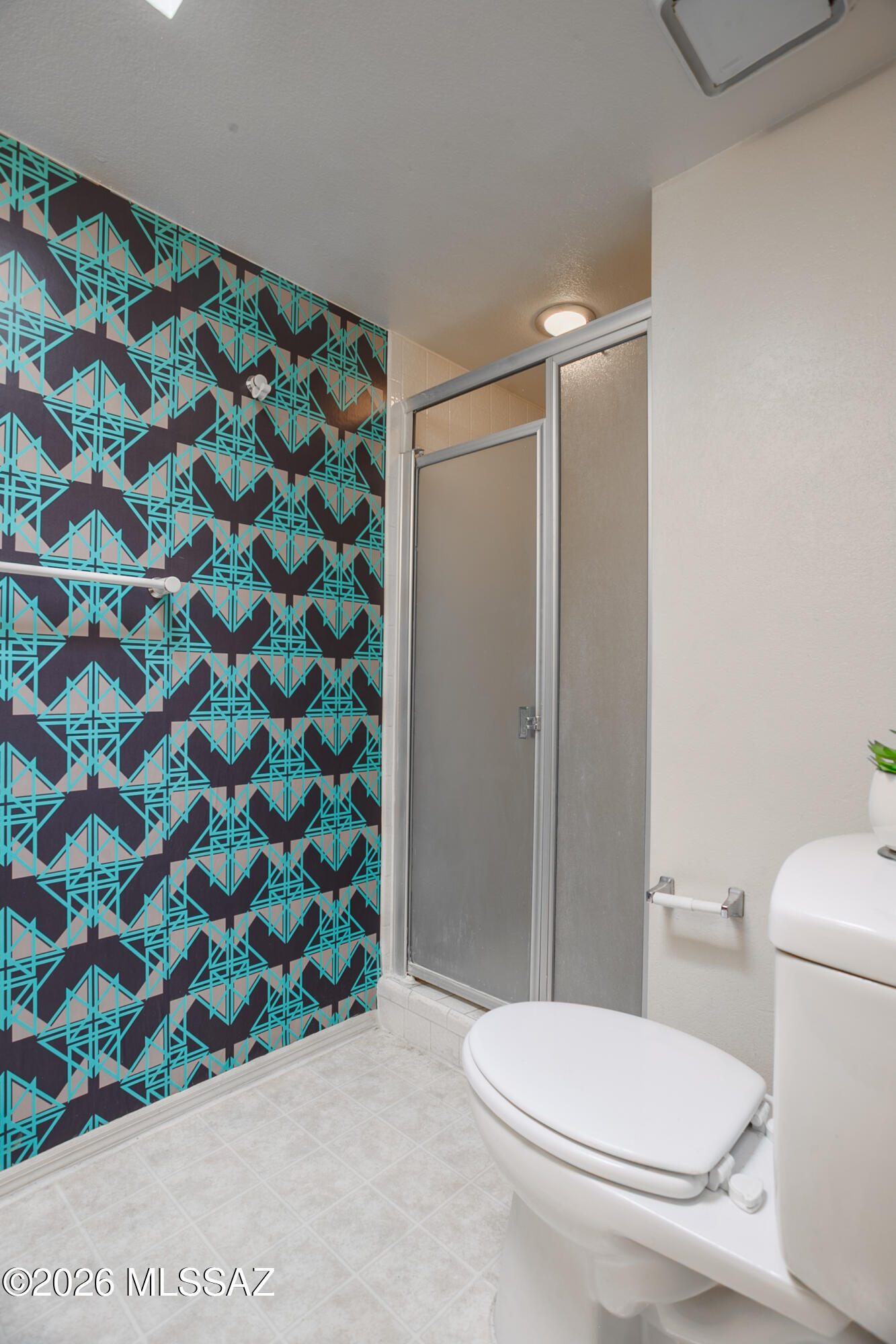 1200 East River Road, Unit B27 Tucson, AZ 85718 - Photo 34 of 40 a white toilet sitting next to a shower curtain
