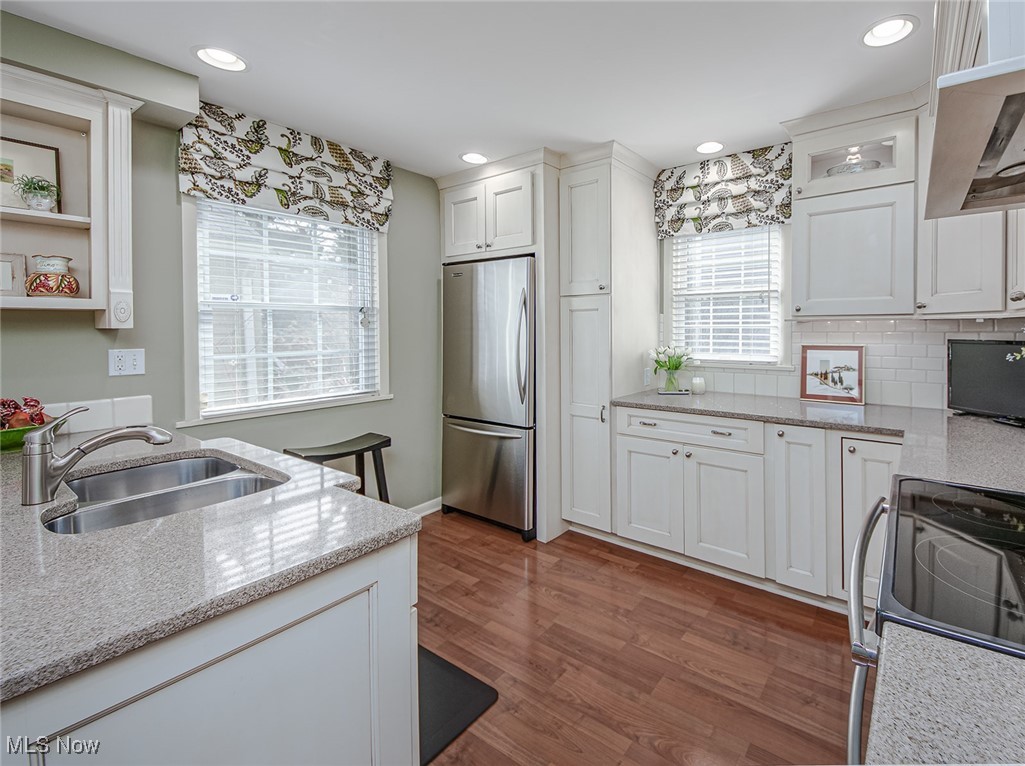 696 Ecton Road Akron, OH 44303 - Photo 10 of 41 Custom valances and all window blinds remain. Two windows allows natural light to flow into this room and bounce off the subway tile backsplash.