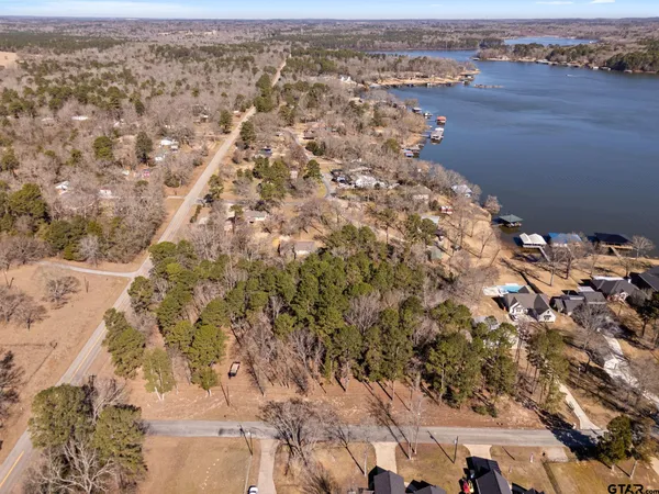 an aerial view of house with yard and mountain view in back