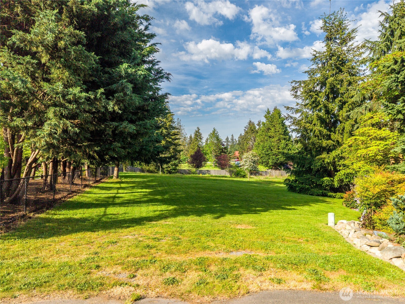 23421 Rim Road Graham, WA 98338 - Photo 13 of 21 a view of a golf course with a lake