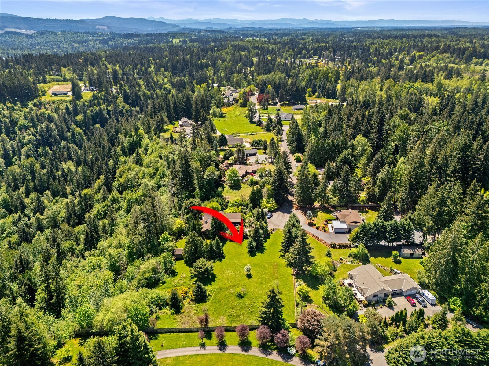 23421 Rim Road Graham, WA 98338 - Photo 7 of 21 a view of a city with lush green forest