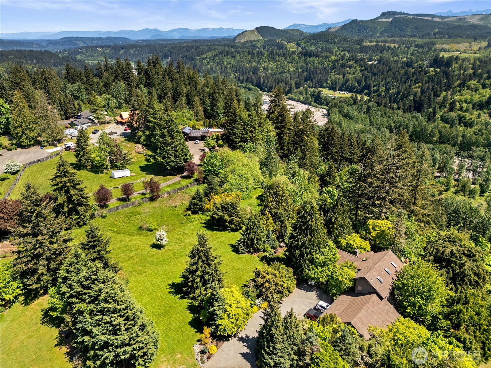 23421 Rim Road Graham, WA 98338 - Photo 9 of 21 a view of a lush green field with mountains in the background