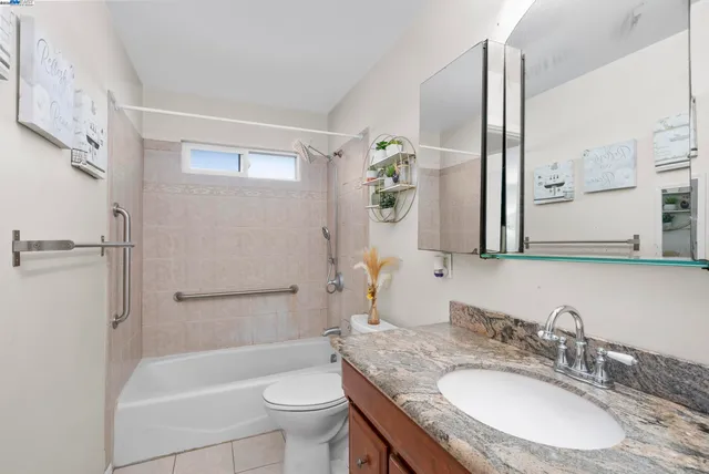 a bed sitting in a bedroom next to a cabinet