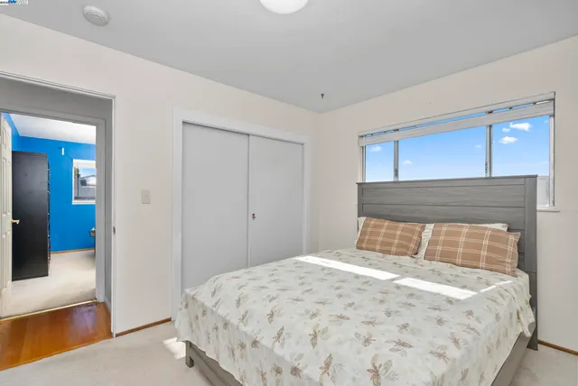 a bedroom with a bed and window