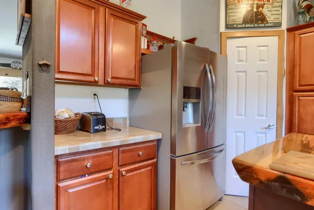 a kitchen with stainless steel appliances granite countertop a refrigerator and a stove top oven