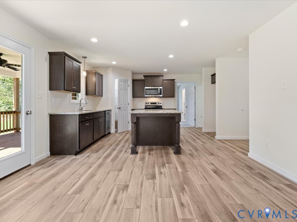 2021 Ridge Road Powhatan, VA 23139 - Photo 11 of 44 a kitchen with stainless steel appliances a microwave a stove a sink and a refrigerator