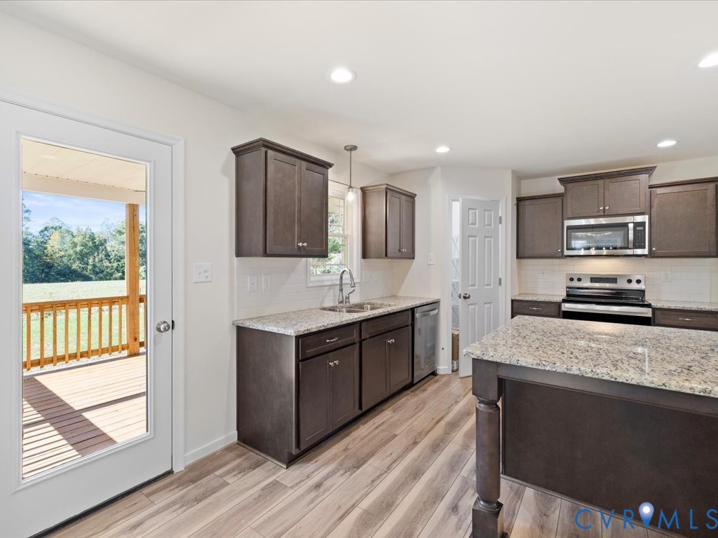 2021 Ridge Road Powhatan, VA 23139 - Photo 12 of 44 a large kitchen with stainless steel appliances granite countertop a stove a sink dishwasher a microwave oven and a refrigerator with wooden floor