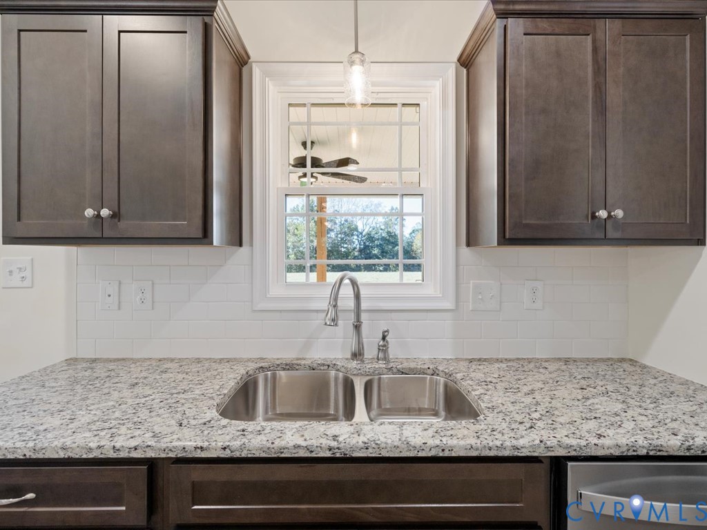 2021 Ridge Road Powhatan, VA 23139 - Photo 16 of 44 a kitchen with granite countertop cabinets sink and window