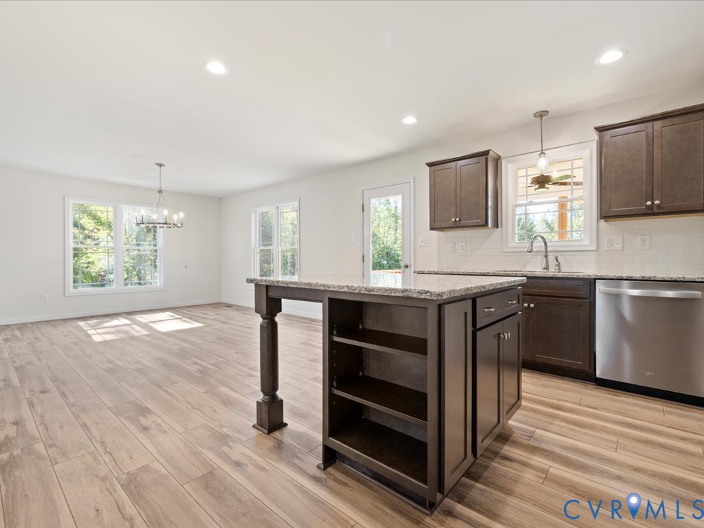 2021 Ridge Road Powhatan, VA 23139 - Photo 17 of 44 a kitchen with stainless steel appliances granite countertop a stove a sink and a microwave