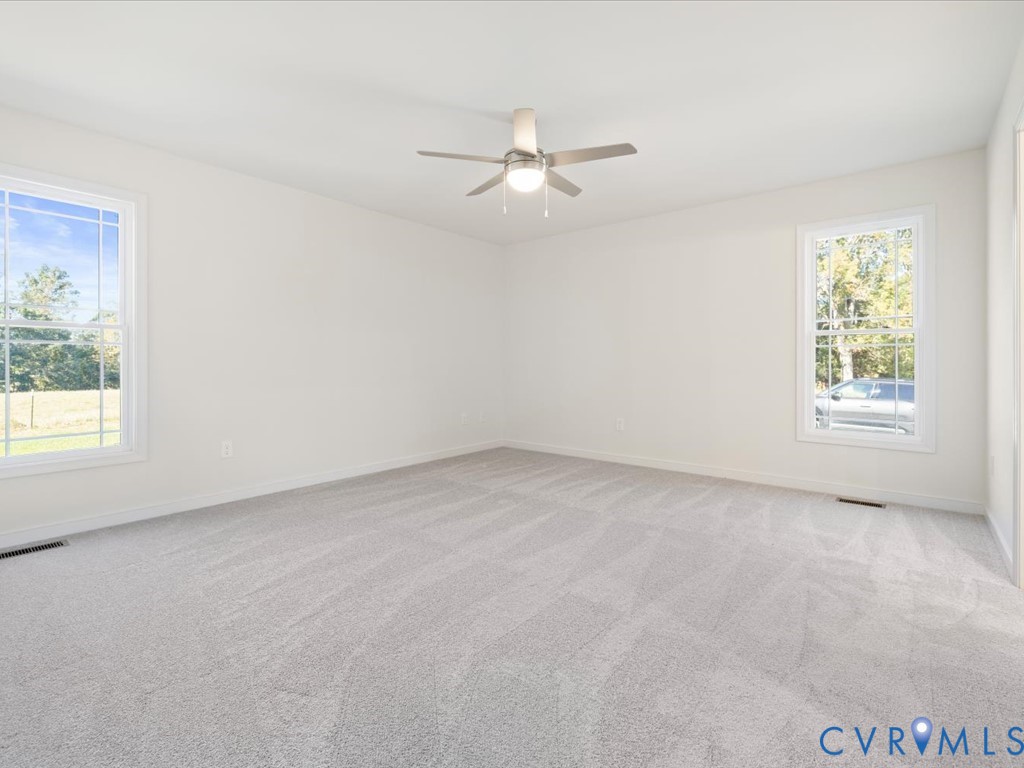 2021 Ridge Road Powhatan, VA 23139 - Photo 18 of 44 an empty room with windows and fan