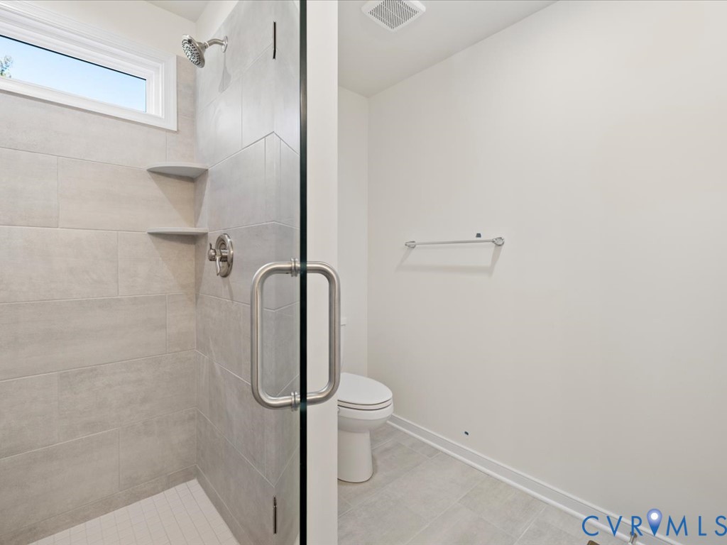 2021 Ridge Road Powhatan, VA 23139 - Photo 21 of 44 a bathroom with a granite countertop toilet and a shower
