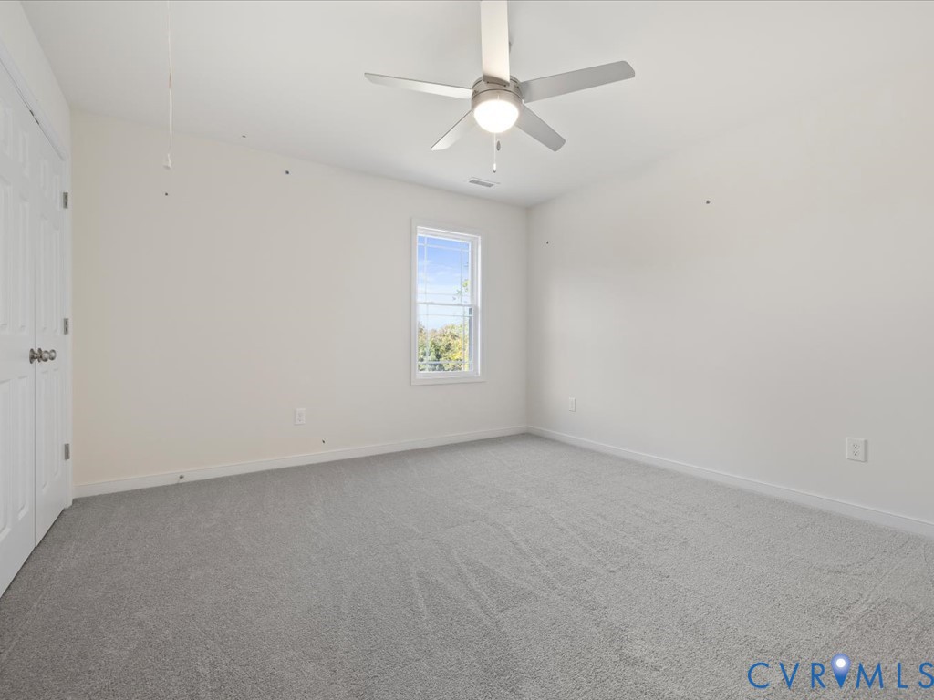 2021 Ridge Road Powhatan, VA 23139 - Photo 29 of 44 an empty room with a window and a ceiling fan