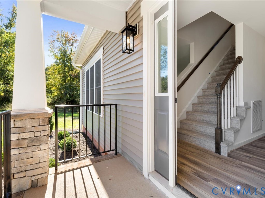 2021 Ridge Road Powhatan, VA 23139 - Photo 5 of 44 a view of a balcony with wooden floor and iron fence