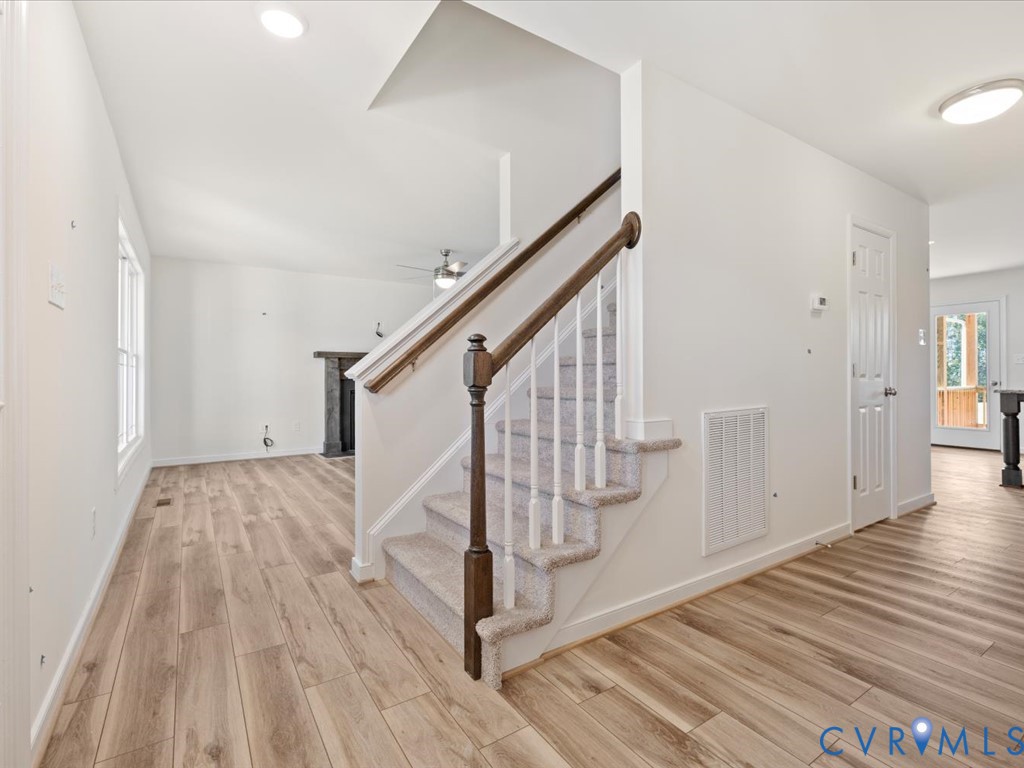 2021 Ridge Road Powhatan, VA 23139 - Photo 7 of 44 a view of a hallway with wooden floor and staircase