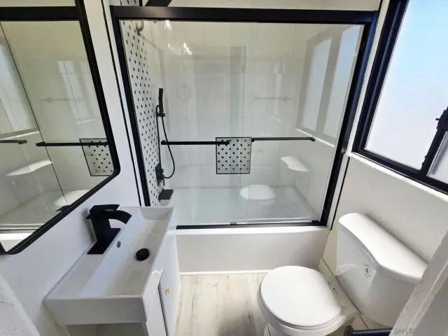 a bathroom with a toilet sink and a mirror