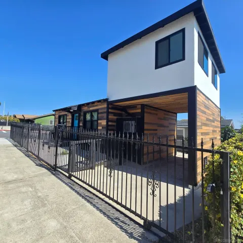 a view of a house with wooden fence