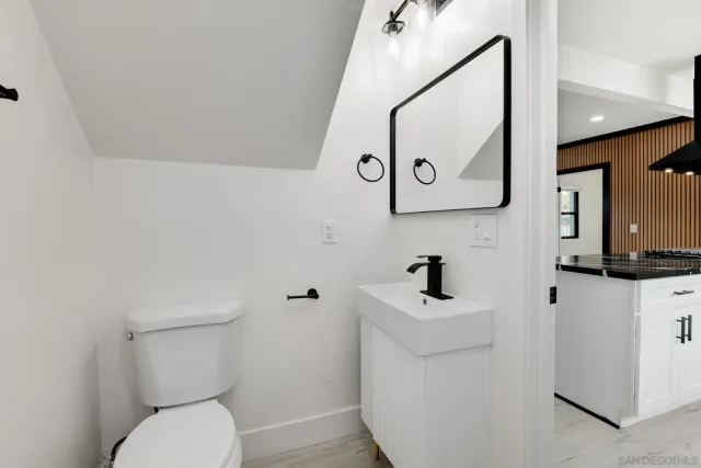 a bathroom with a toilet a sink and mirror
