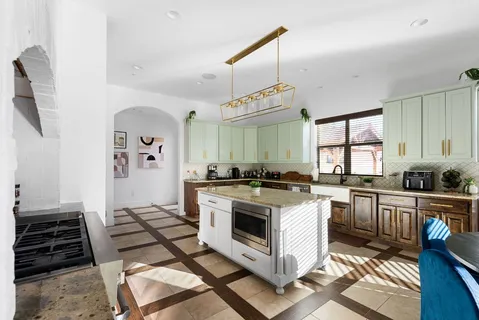 a kitchen with sink stove and cabinets