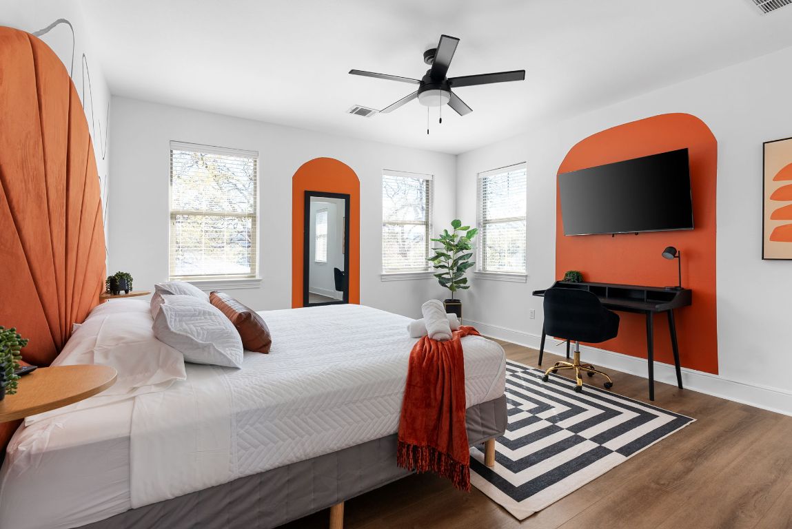 1116 Terjo Lane Austin, TX 78732 - Photo 21 of 40 a bedroom with a bed and a chandelier